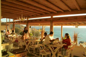 Tables overlooking the sea at Bandanna Tourlos.